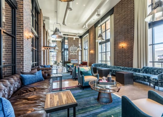 High-vaulted ceiling common area with cozy sofas at The Case Building in Dallas, TX