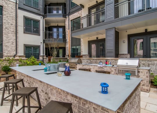 Barbecue Area in Courtyard at The Alastair at Aria Village Apartment Homes in Sandy Springs, Georgia, GA