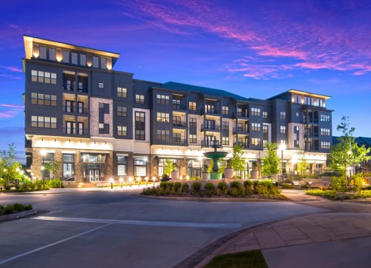 a night view of the building with lights on at The Alastair at Aria Village Apartment Homes in Sandy Springs, Georgia, GA