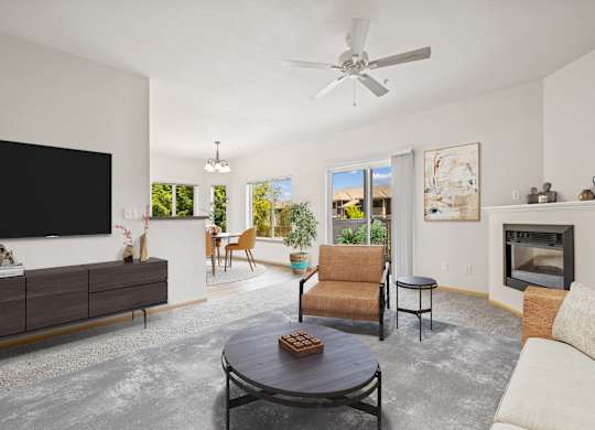 Virtually staged living room with a fireplace in the Jackson floor plan at The Madison apartments in Olympia, WA.