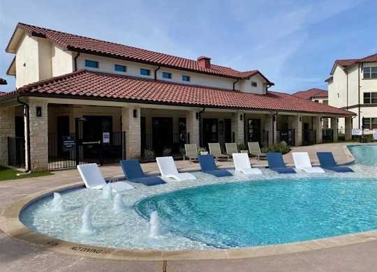 A pool with a fountain in the middle of it.