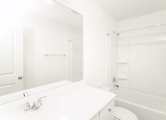 a bathroom with a bathtub and a sink at Beacon at Meridian, San Antonio, 78245