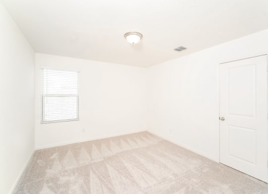 a bedroom with white walls and a white door at Beacon at Meridian, San Antonio, TX
