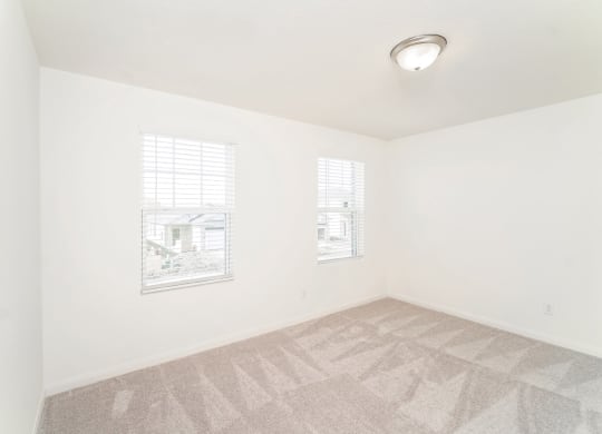 a bedroom with white walls and a carpeted floor at Beacon at Meridian, San Antonio, TX 78245