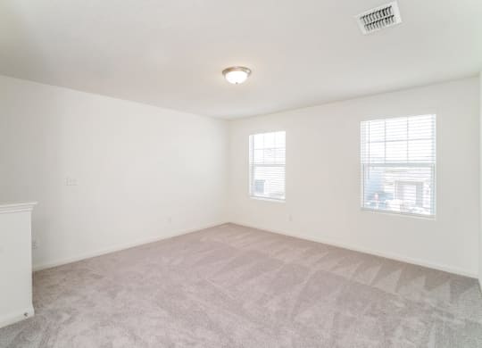 a bedroom with white walls and carpet at Beacon at Meridian, San Antonio, TX