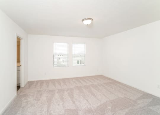 a bedroom with white walls and a carpeted floor at Beacon at Meridian, San Antonio, TX 78245