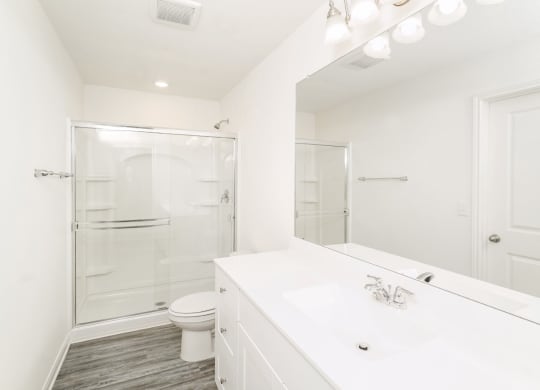 a bathroom with a toilet sink and shower at Beacon at Meridian, San Antonio