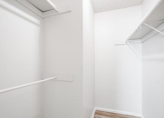 A1 white closet with a shelf and a vent at Vine Apartments in Arlington, TX