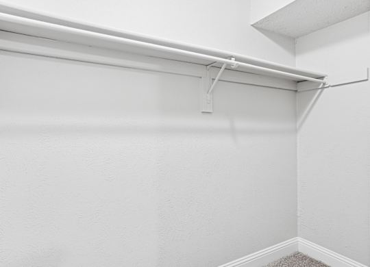 B1 closet with a white shelf and a white ceiling at Vine Apartments in Arlington, TX