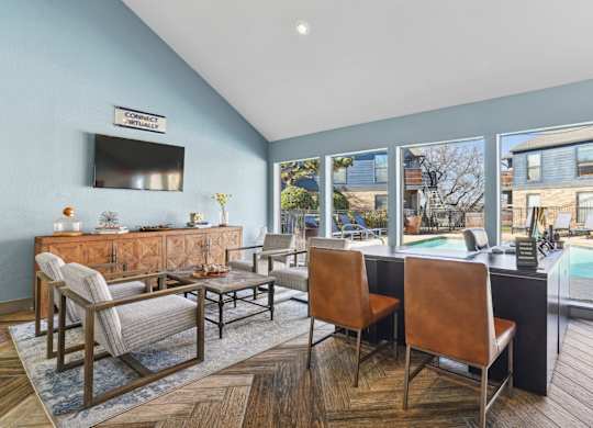 A leasing office with chairs and a large window at Vine Apartments in Arlington, TX