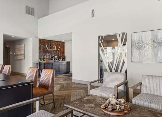 A modern leasing office with a wooden floor and a table at Vine Apartments in Arlington, TX