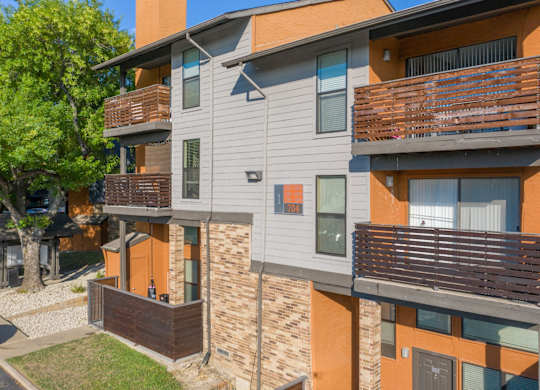 A modern apartment building with balconies at Vine Apartments in Arlington, TX