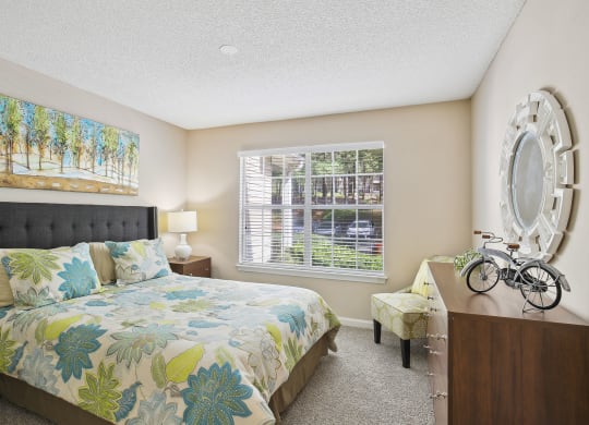Model bedroom with a bed and a window at Wellington Ridge in Lawrenceville, GA