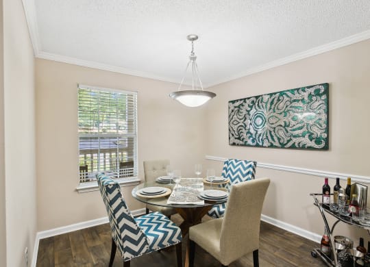 a dining room with a table and chairs and a window at Wellington Ridge in Lawrenceville, GA