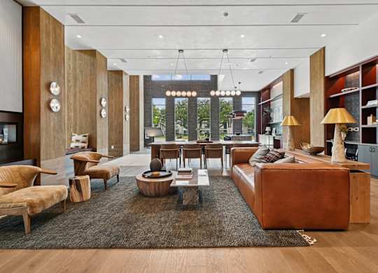 Leasing office lounge space with comfortable couches at Whispering Pines at Westdale Hills in Euless, TX