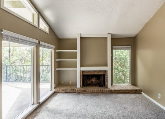 the living room of an empty house with a fireplace