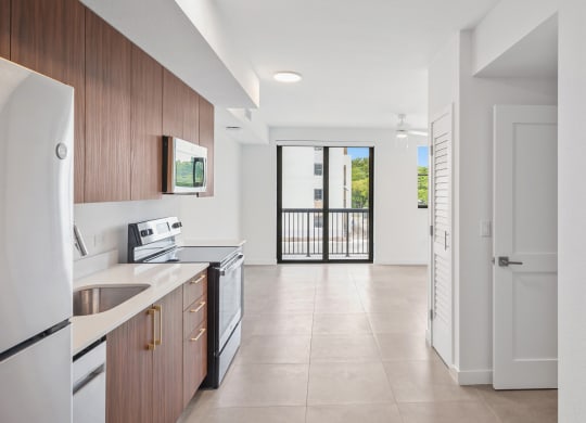 a kitchen with wooden cabinets and a white tiled floor