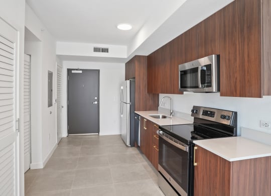 a kitchen with a stove top oven next to a refrigerator