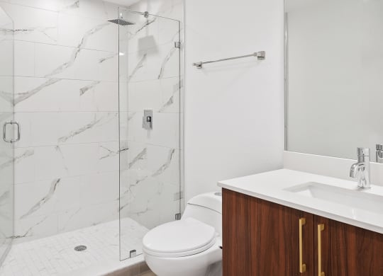 a bathroom with a toilet sink and shower