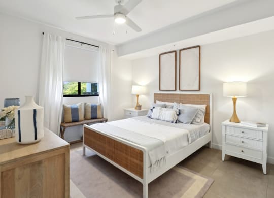 Bedroom 1 in B1 Floor Plan with large bed and nightstand at Westgate on University in Lauderhill, FL