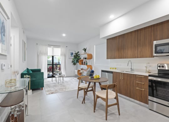 Kitchen with wooden cabinets and stainless steel appliances in A2 Floor Plan at Westgate on University in Lauderhill, FL