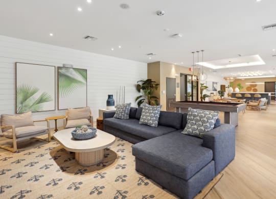 Resident Social and Gaming Lounge with L-shaped couch at Westgate on University in Lauderhill, FL