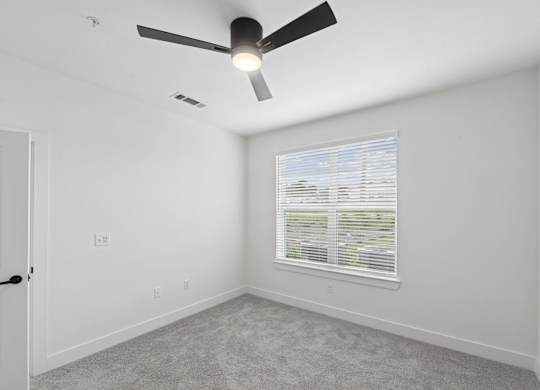 B2 bedroom with a ceiling fan and a window with blinds at Whispering Pines at Westdale Hills in Euless, TX