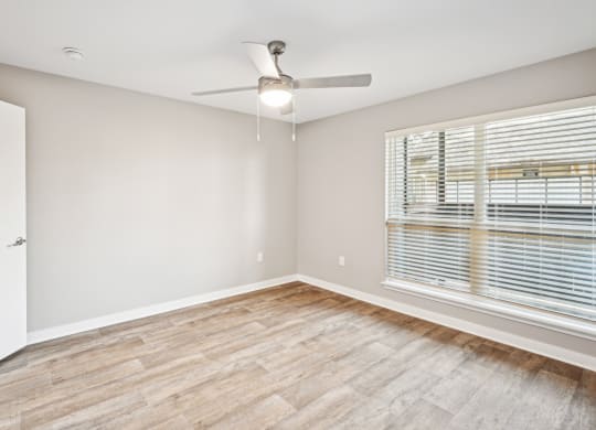 Cozy bedroom area in the D5 floor plan at Windridge On The Parkway Apartments in Dallas, TX