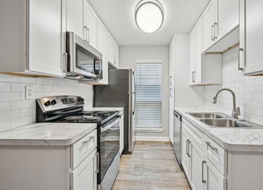 Kitchen area in the D5 floor plan at Windridge On The Parkway Apartments in Dallas, TX