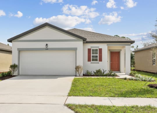 a home with a white house and a brown door at Beacon at Woodland Village, Florida, 32724