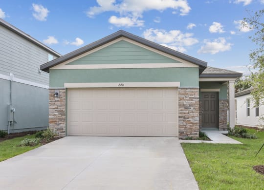 a house with a garage door at Beacon at Woodland Village, DeLand