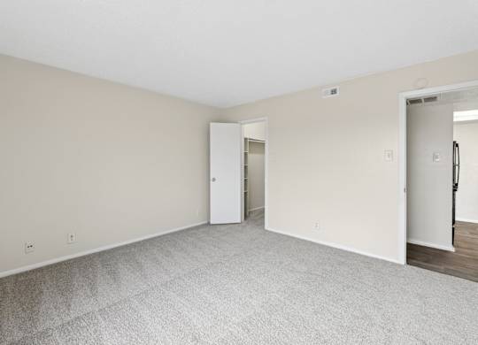 A2 bedroom with carpet and door at Westdale Pointe in Austin, TX