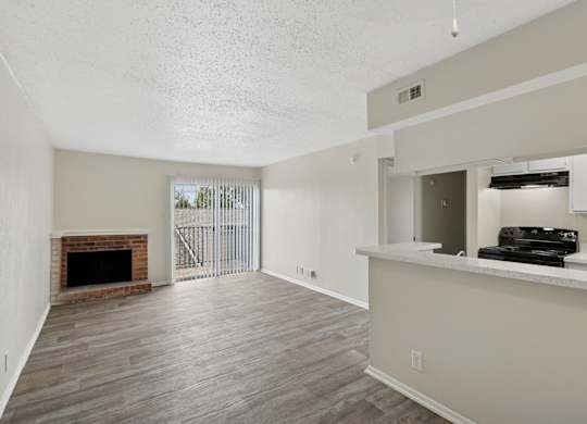 A2 living room with fireplace and sliding door at Westdale Pointe in Austin, TX