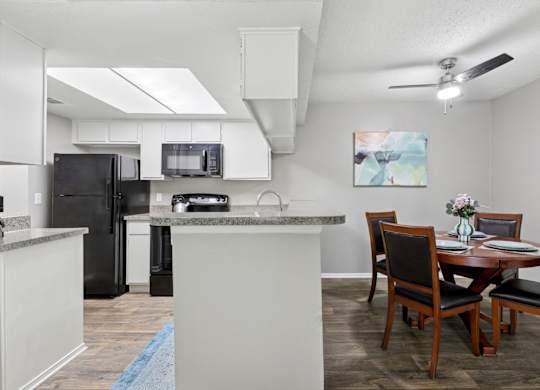 B1 kitchen and dining area with a table and chairs at Westdale Pointe in Austin, TX