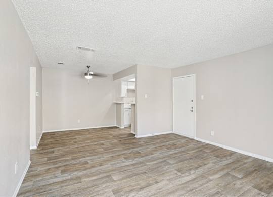 A5 living room with vinyl wooden flooring at Windridge on the Parkway apartments in Dallas, TX