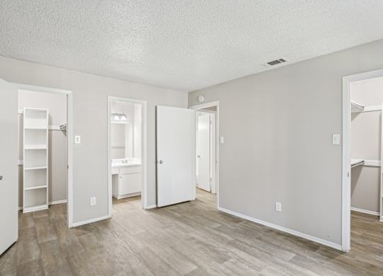 A6 bedroom with two walk-in closets at Windridge on the Parkway apartments in Dallas, TX