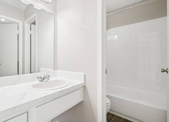 B6 white bathroom with a sink and a mirror.