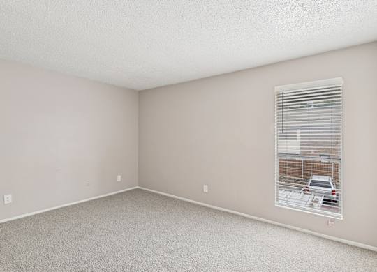 Carpeted B6 bedroom with a window at Windridge on the Parkway in Dallas, TX