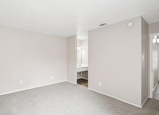 B6 bedroom with a white ceiling and carpeted floor at Windridge on the Parkway in Dallas, TX