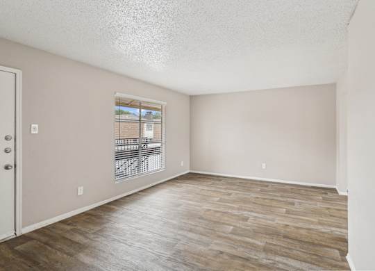B6 living room with wooden flooring and a window at Windridge on the Parkway in Dallas, TX