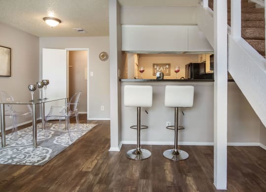 a living room with a bar and a dining room
