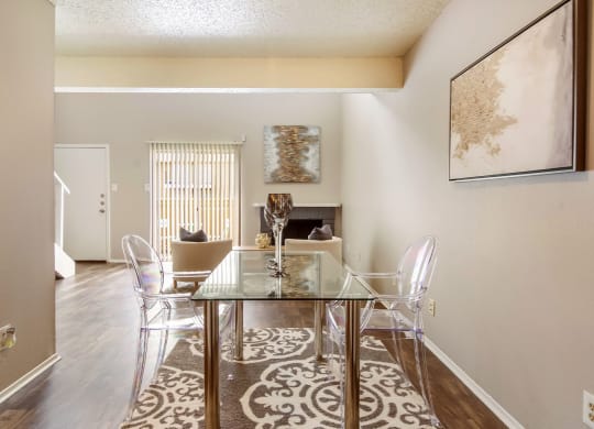 a dining room with a glass table and chairs