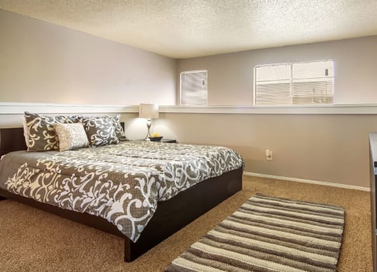 a bedroom with a large bed and a window