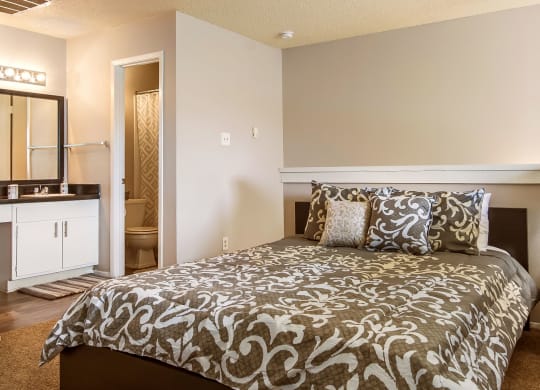 a bedroom with a bed and a bathroom with a sink