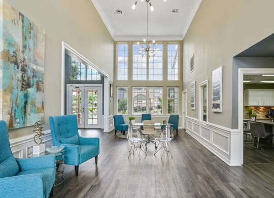 a living room with blue furniture and a large window