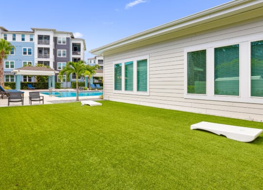 Corn hole boards by the pool at Dunedin Commons apartments in Dunedin, FL