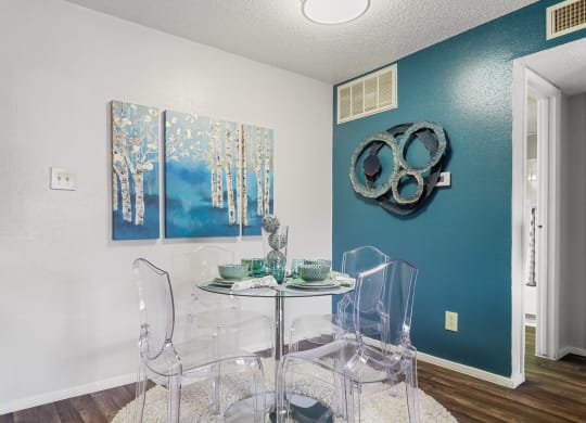 a dining room with a table and chairs