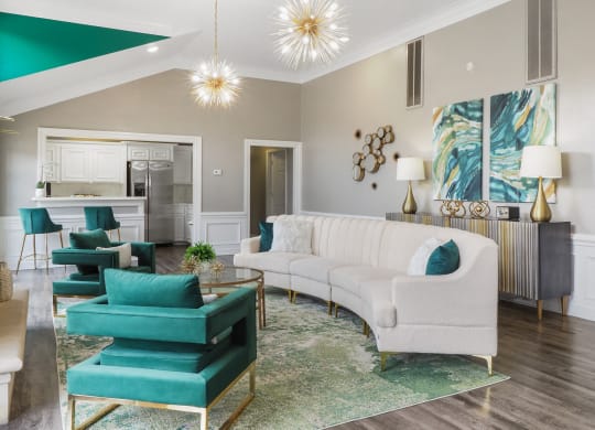 a living room with a white couch and turquoise chairs