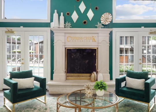 a living room with green walls and a fireplace