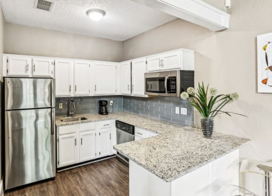 Leasing office kitchen with fridge and microwave at Hunters Chase in Austin, TX